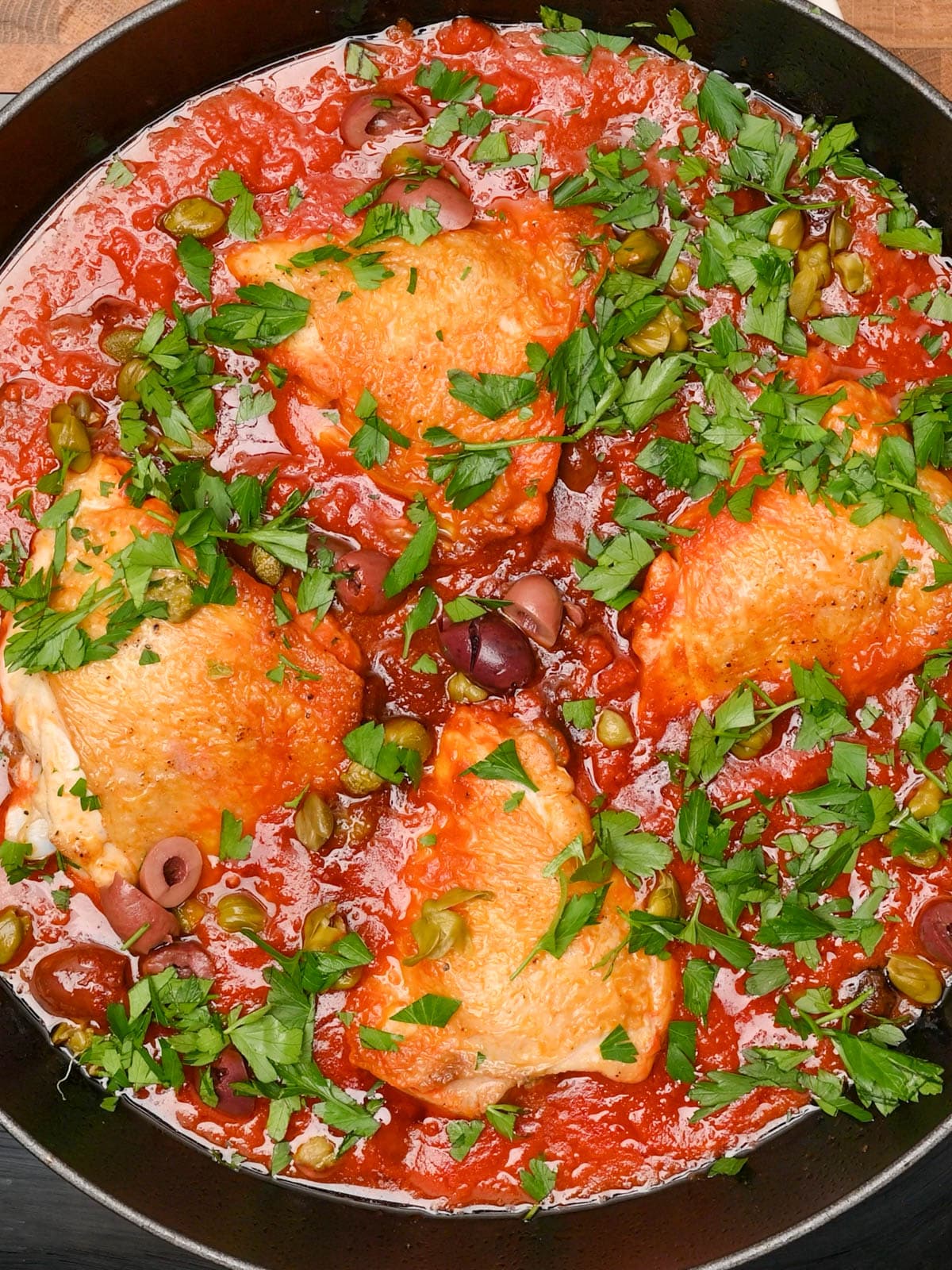 adding parsley and olives to the pot