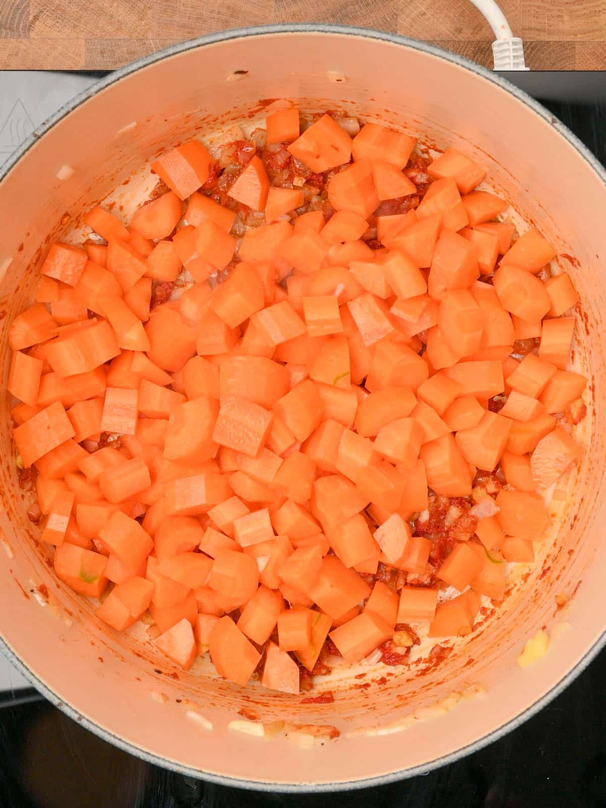 adding carrots to the pot