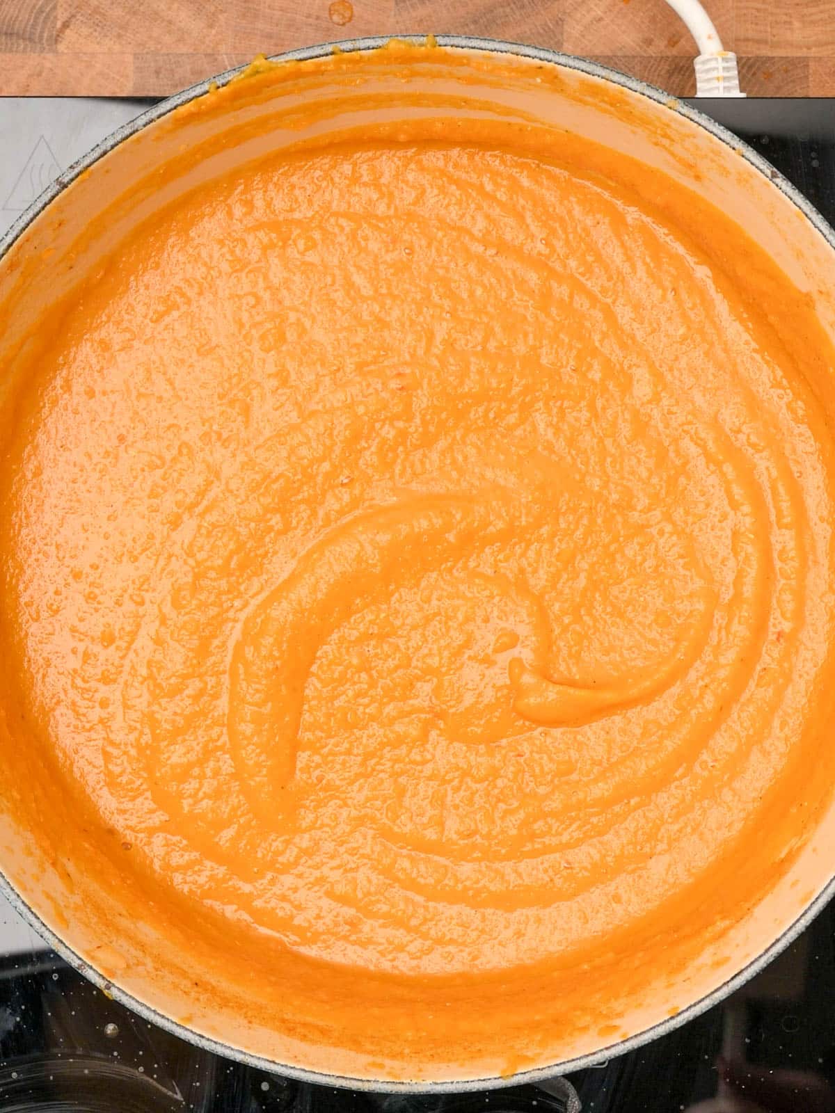 photo of creamy carrot and red lentil soup after blending
