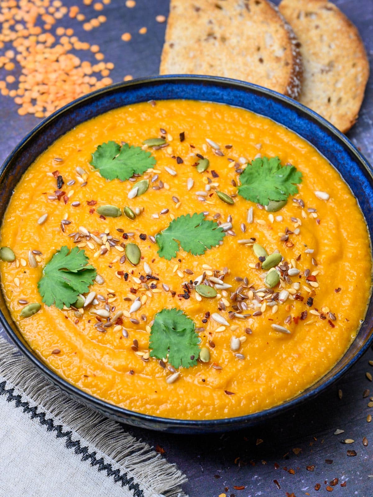 carrot and lentil soup with seeds on top