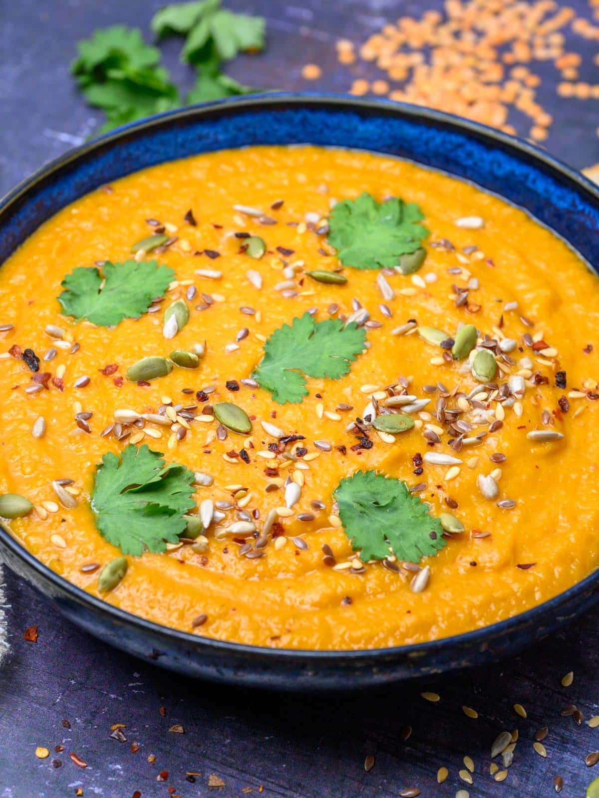 close up photo of a blue bowl with soup