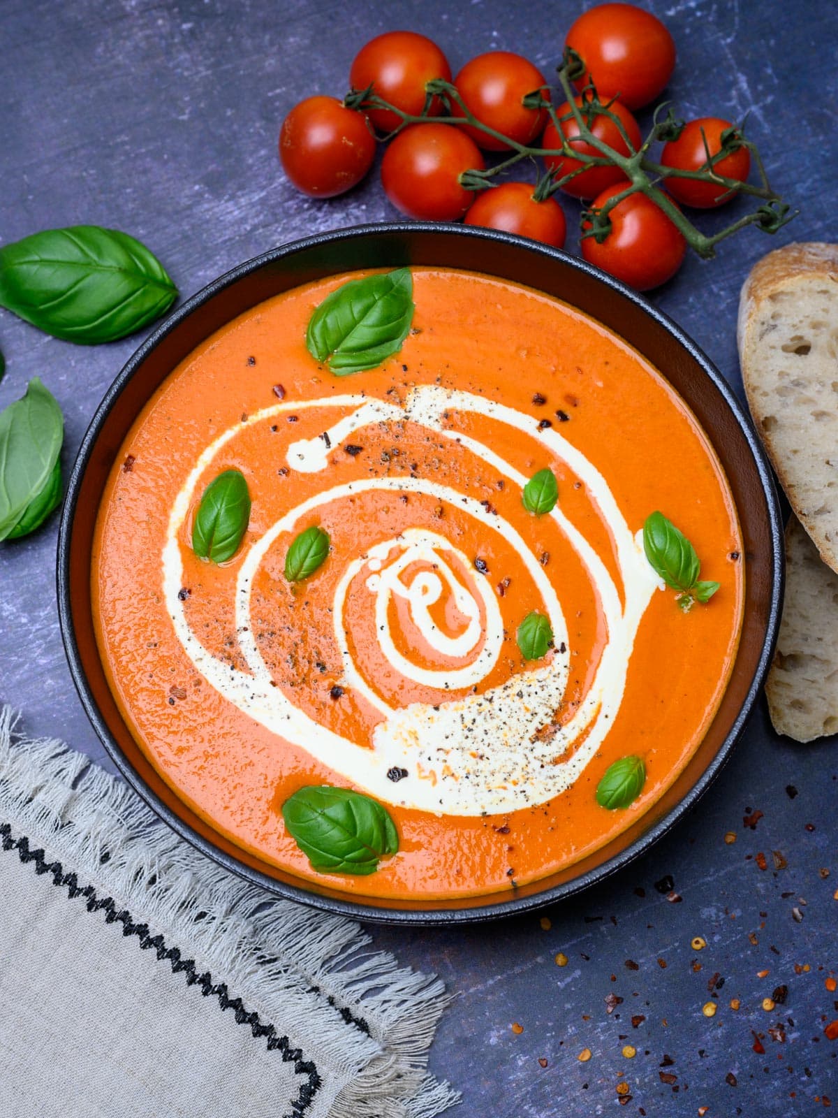 A bowl of roasted red pepper and tomato soup.