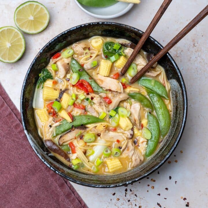 a bowl of soup with chicken and snap peas