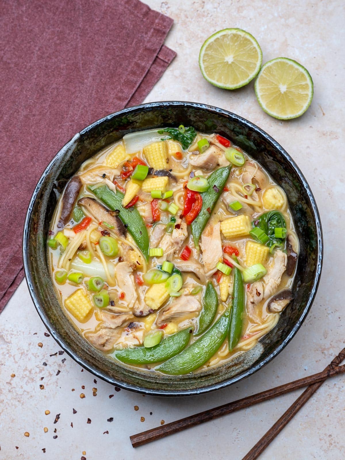 thai green curry soup with limes on the side