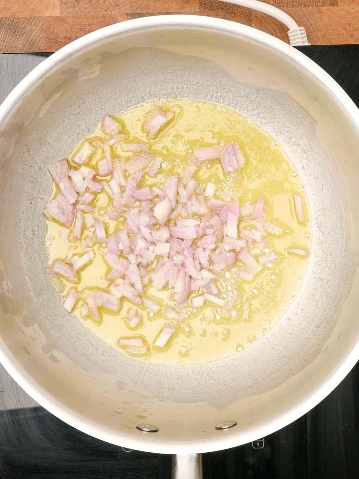 adding onion to a Creamy Lemon Pasta Sauce