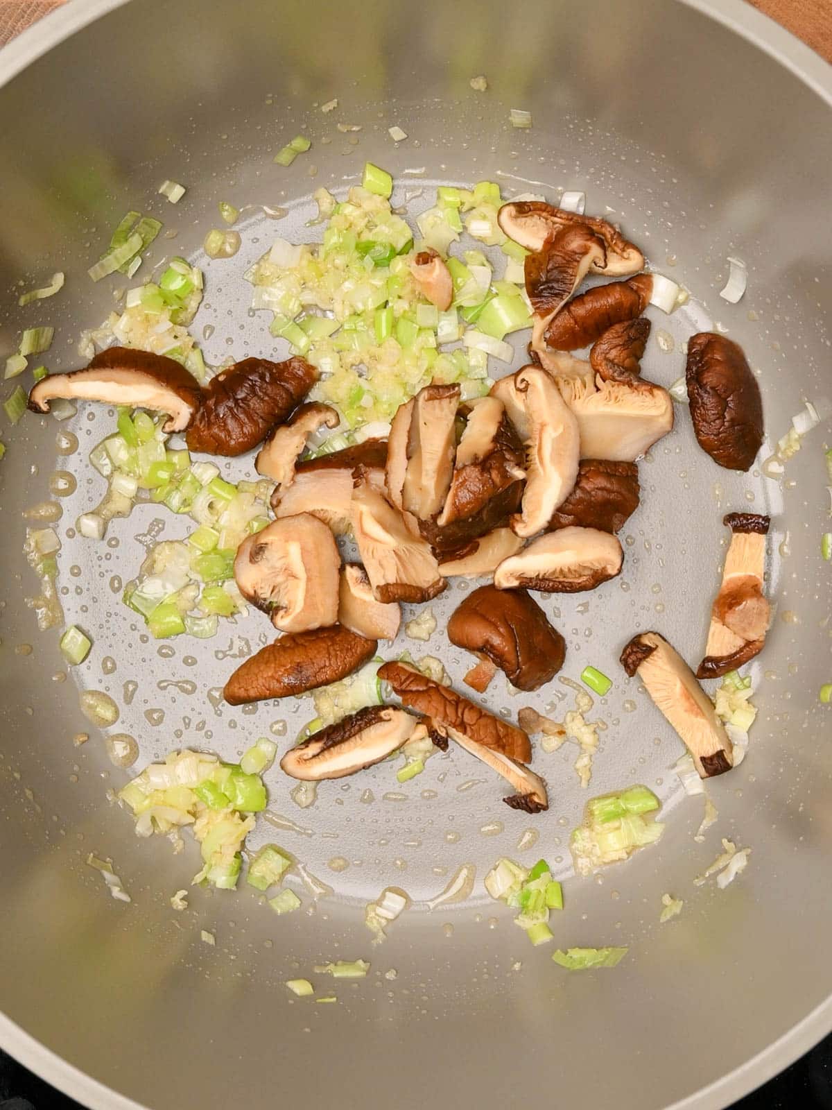 adding mushrooms to wonton soup