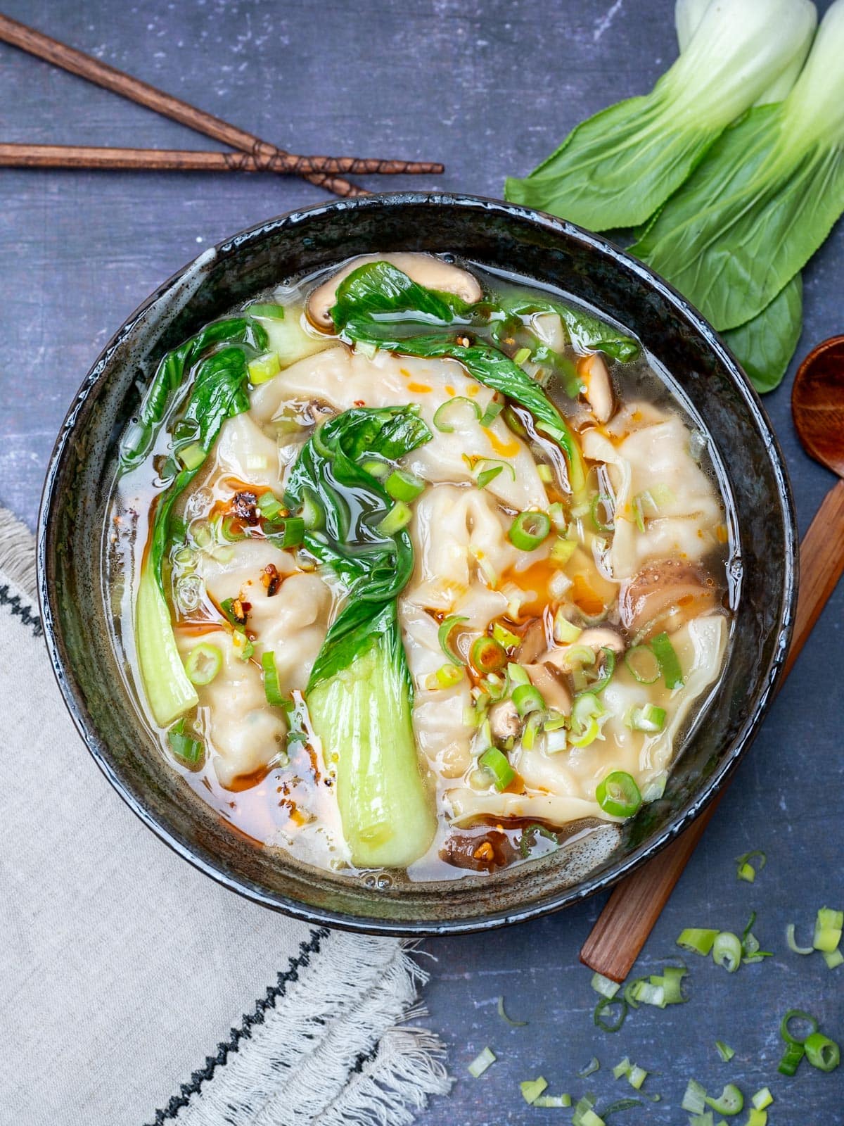 black bowl with bok choy and spring onions on top