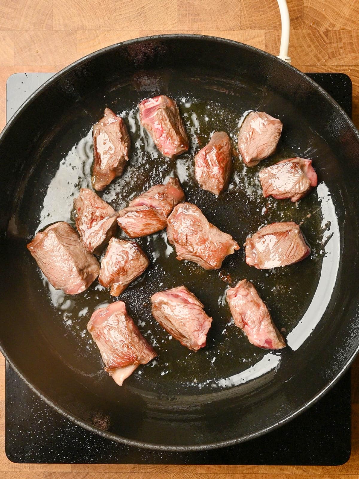 frying the meat of an italian beef stew