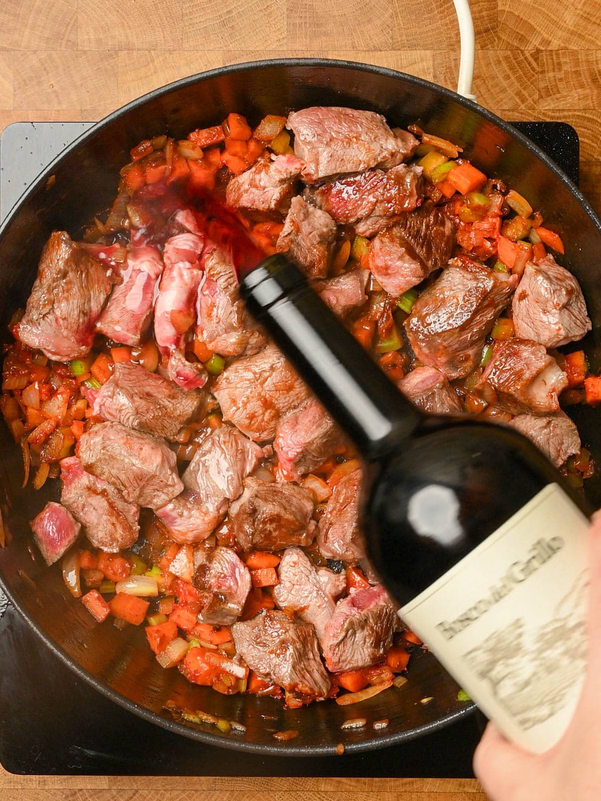 pouring wine into the cooking pan