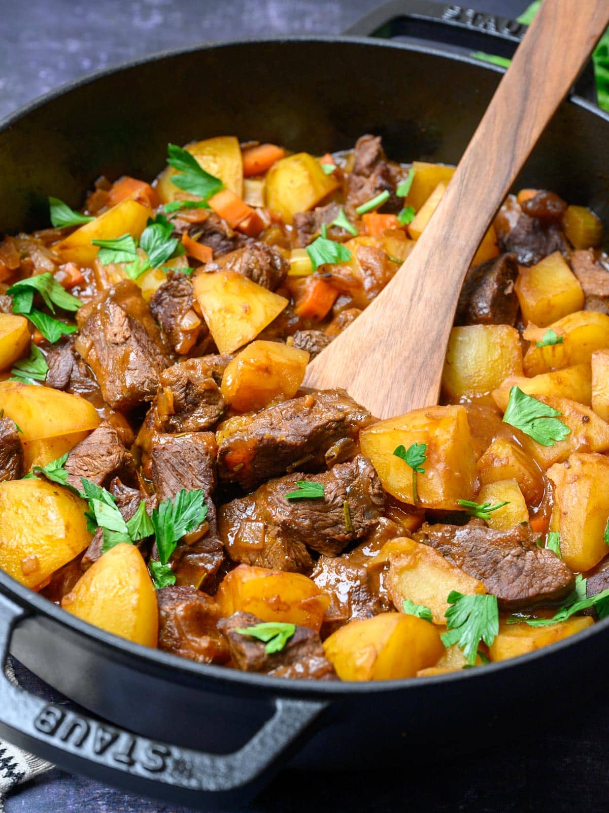 black pan with a spatula in a potato and meat mix
