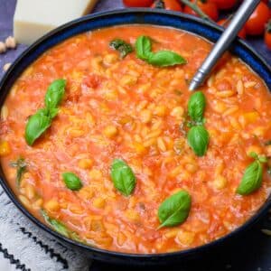 bowl of soup with basil on top