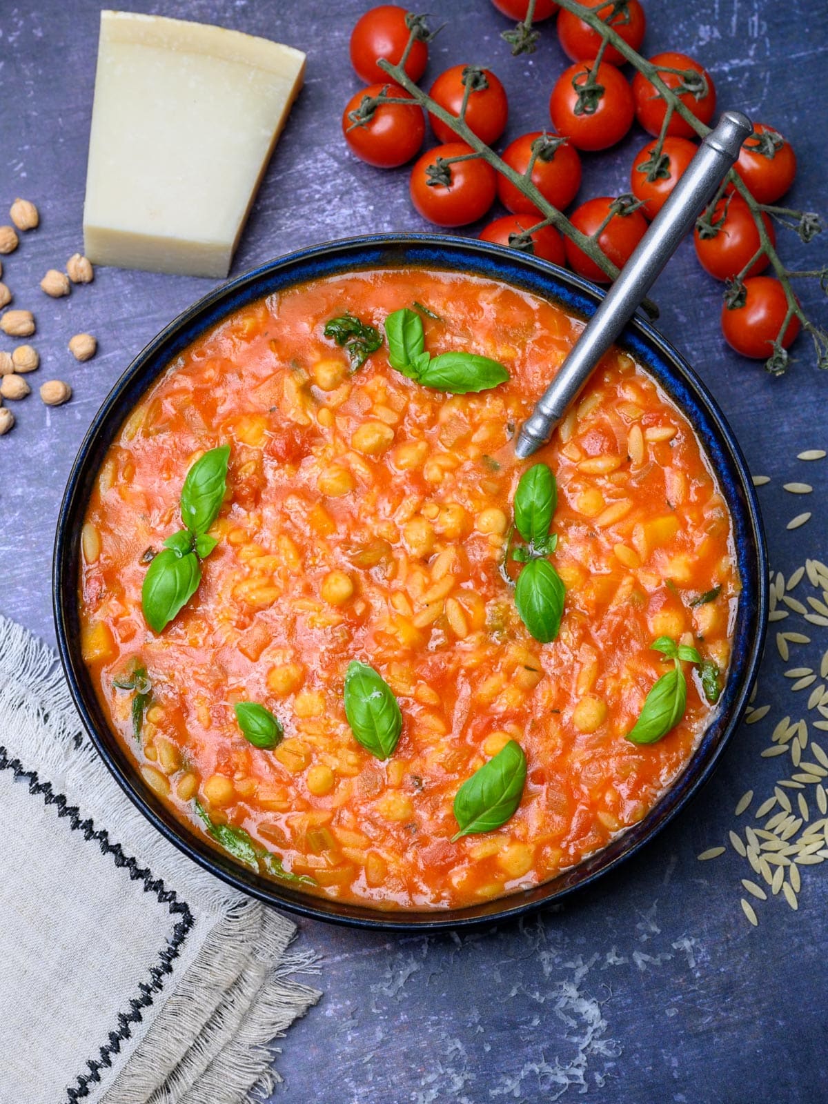 chickpea orzo soup with tomatoes on the side